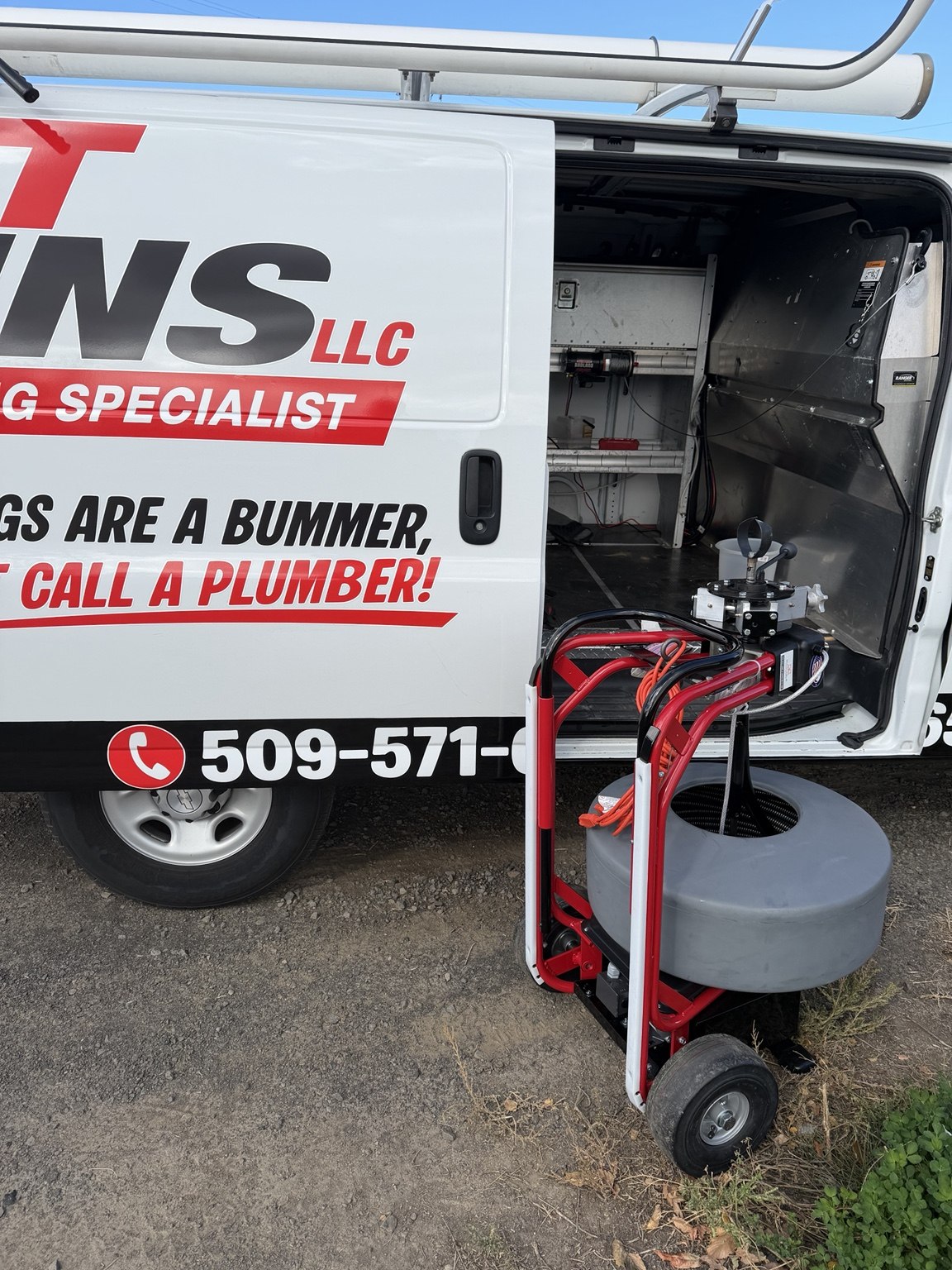 Professional cable machine next to the branded Just Drains van